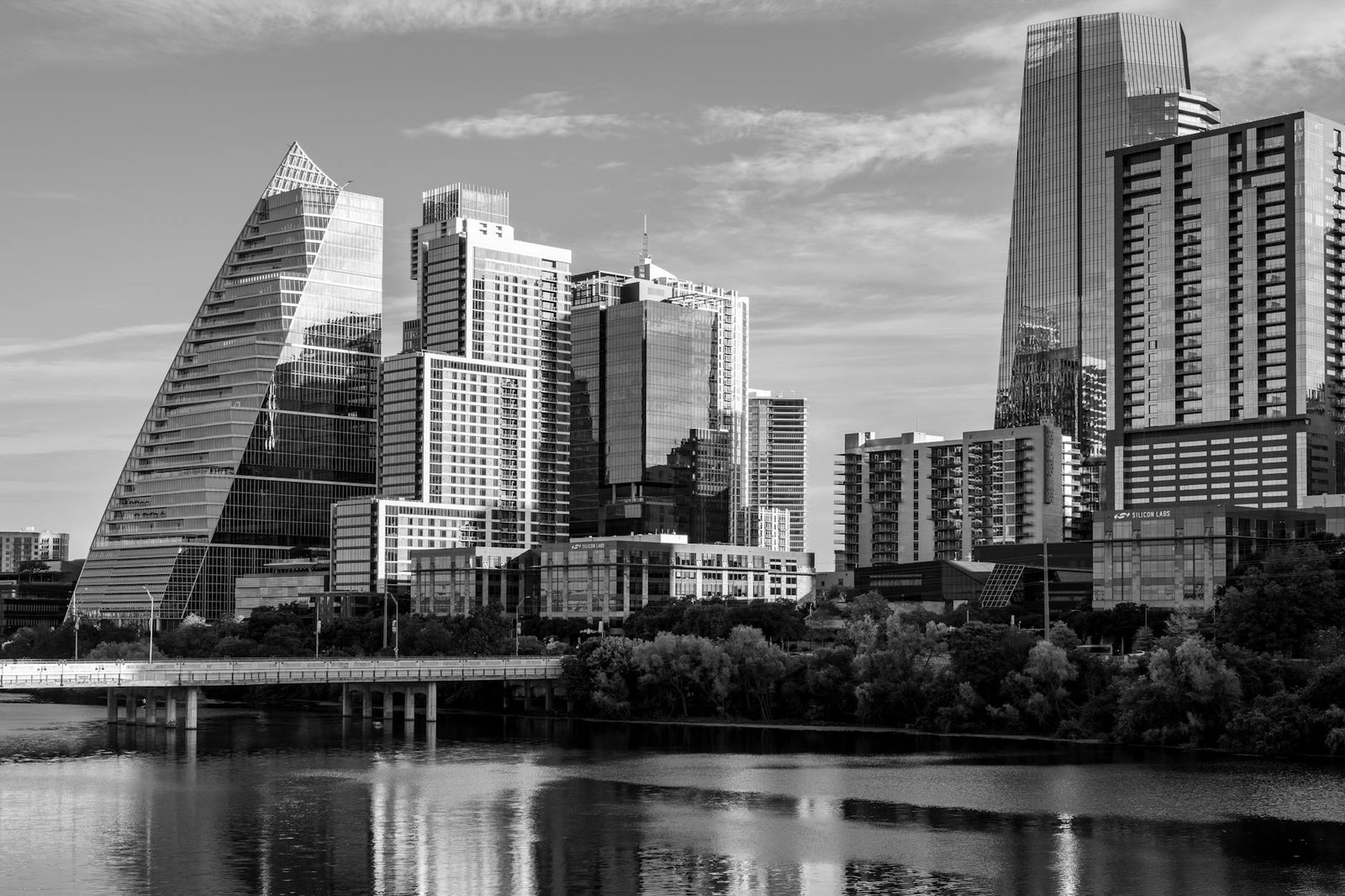 Black and white view of Austin's modern skyline with reflections on water.
