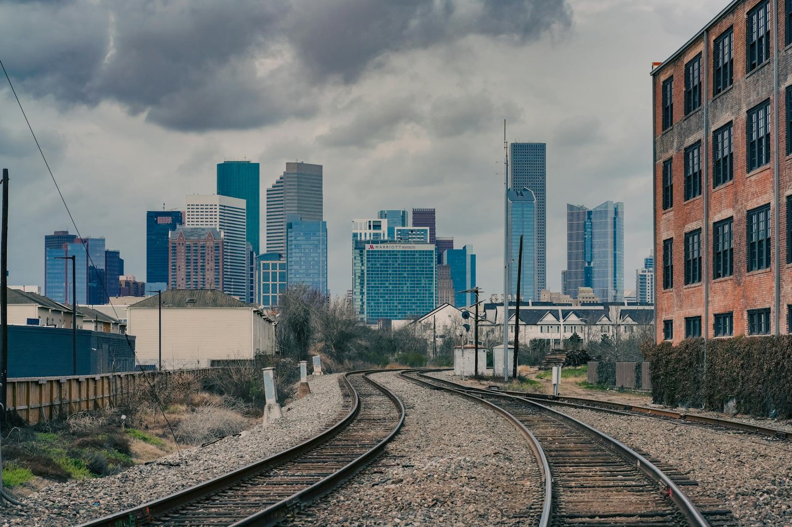 Dramatic view of Houston's skyline from a railway perspective, showcasing urban charm.