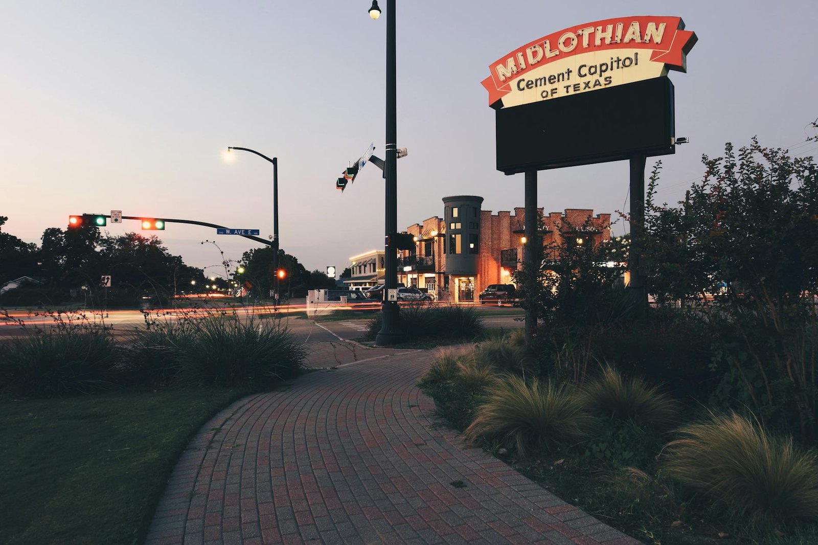 Downtown Midlothian, Texas at dusk showcasing signage and urban architecture.