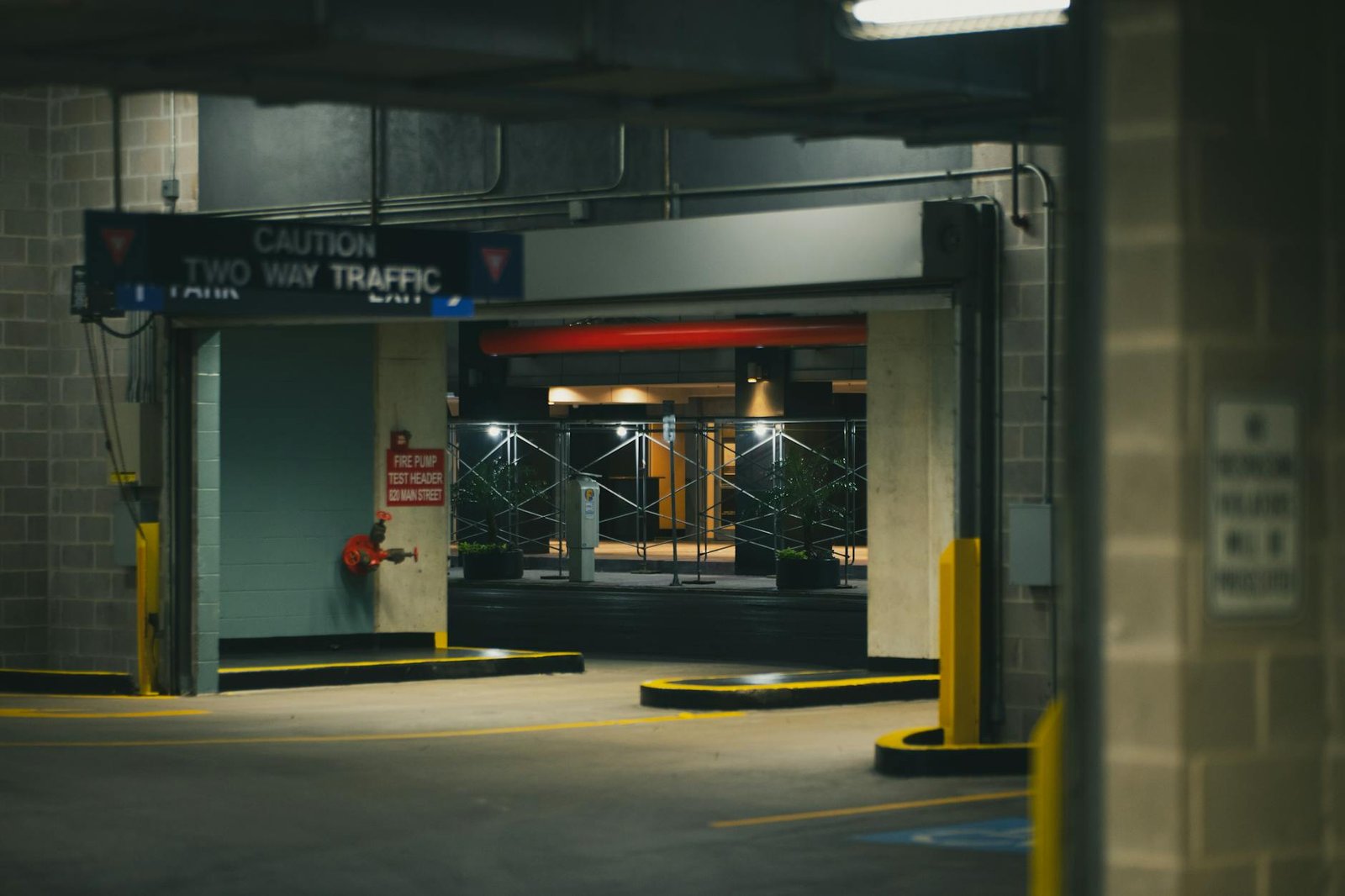 Explore the moody ambiance of a Houston parking garage at night with industrial architecture and dim lighting.