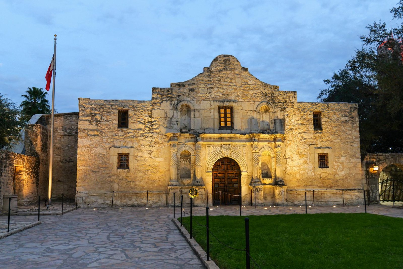 The historic Alamo in San Antonio, Texas, beautifully lit at dusk, showcasing its iconic architecture.