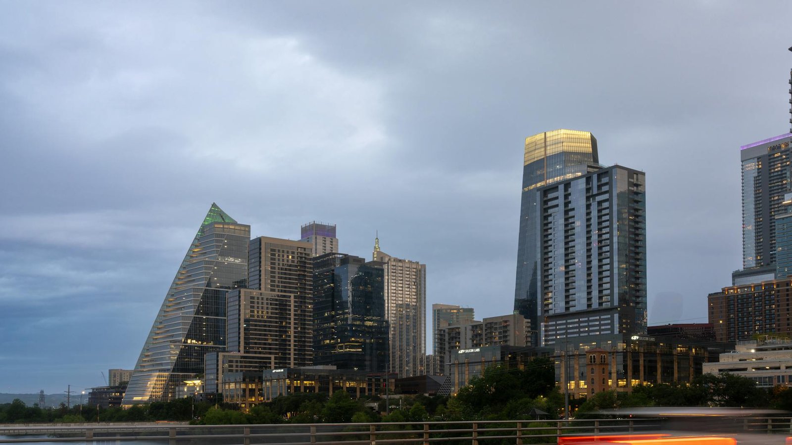 Stunning view of Austin's skyline at dusk with modern skyscrapers under a dramatic sky.