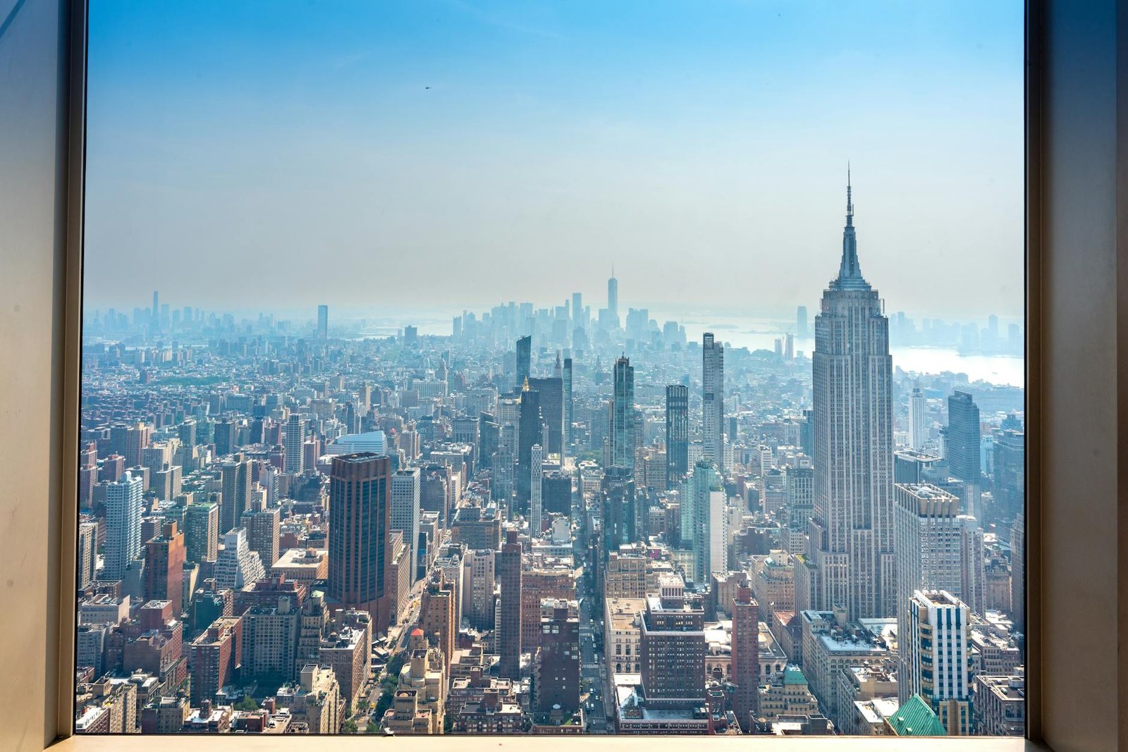 A breathtaking view of New York City skyline featuring the iconic Empire State Building on a clear day.